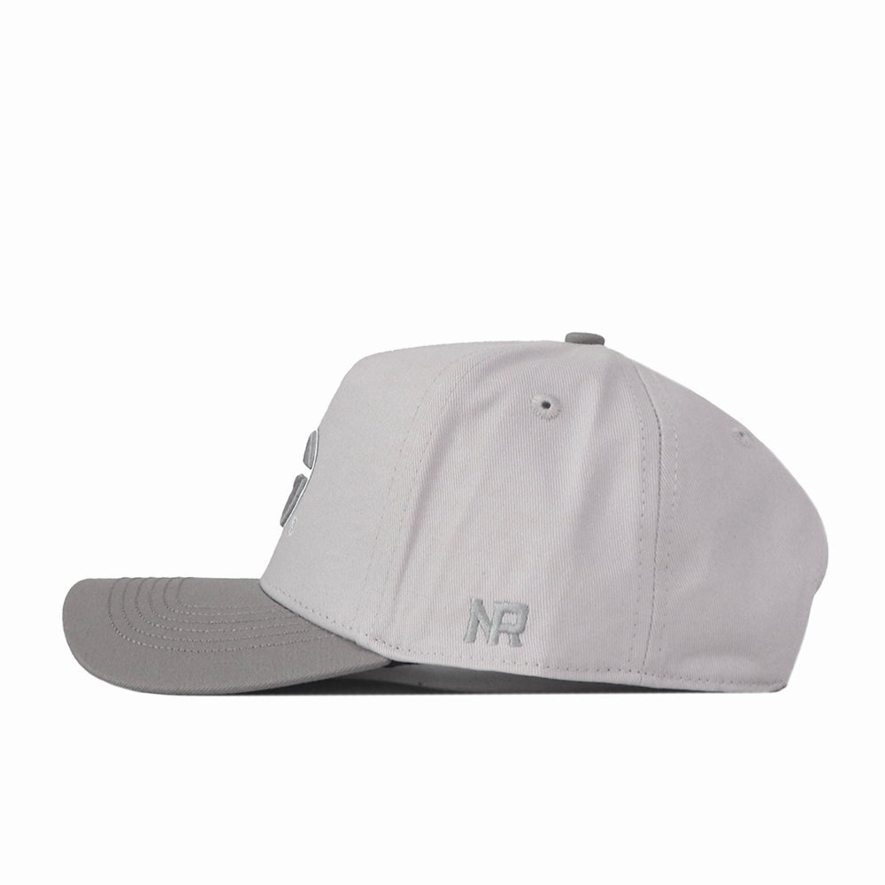 A Georgia Graphite Hat by No Rivals, featuring a light gray snapback design with a darker gray brim, is shown from the side against a plain white background. The embroidered NR near the back offers a subtle logo detail, making it perfect for your gameday fit.