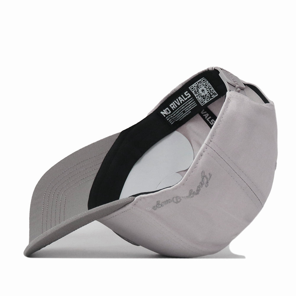 A light gray Georgia Graphite Hat by No Rivals is flipped inside out, revealing black and white labels, a QR code, and detailed curved brim stitching. The mirrored outer text gives your gameday fit a distinctive edge.