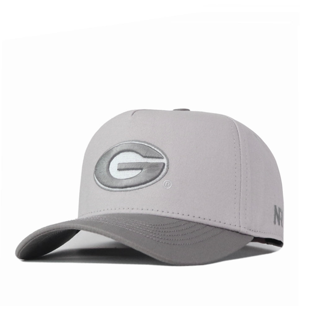 The Georgia Graphite Hat by No Rivals is a light gray baseball cap with a curved brim, showcasing a large embroidered G logo on the front and NR initials on the side—an ideal gameday fit.