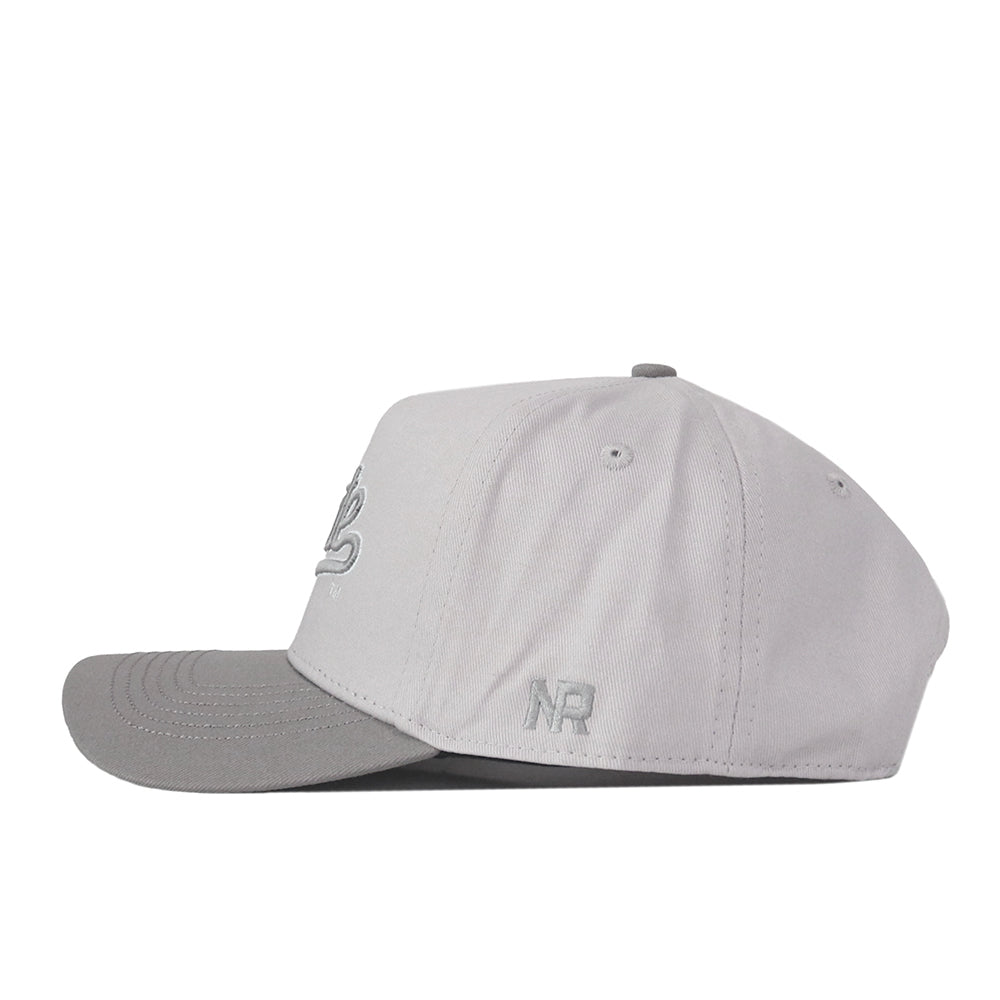 A Mississippi State Graphite Hat by No Rivals, this light gray baseball cap features a curved brim and a subtle embroidered logo on the front. The letters “NR” are stitched near the back, making it an ideal choice for your gameday outfit.