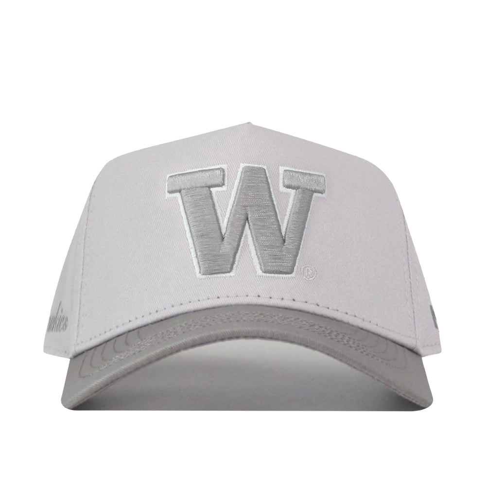 The No Rivals Washington Huskies Graphite Hat is a white baseball cap with a prominent silver “W” embroidered on the front and a classic snapback closure, shown from the front against a plain white background—perfect for topping off your Gameday Fit.