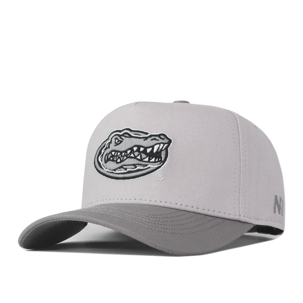Introducing the Florida Gators Graphite Hat by No Rivals—a sleek gray cap showcasing a striking black and white embroidered alligator logo on the front, “NF” lettering on the side, and an adjustable snap back closure for a comfortable fit on gameday.