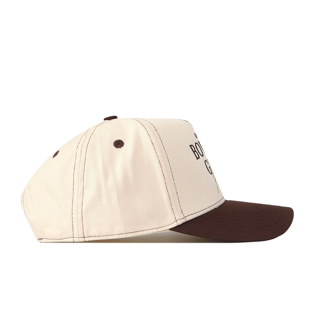 The Bowling Green State Falcons Vintage Hat by No Rivals, made from premium cotton in beige with a dark brown brim and top button, showcases an embroidered logo and is pictured from the side against a white background.