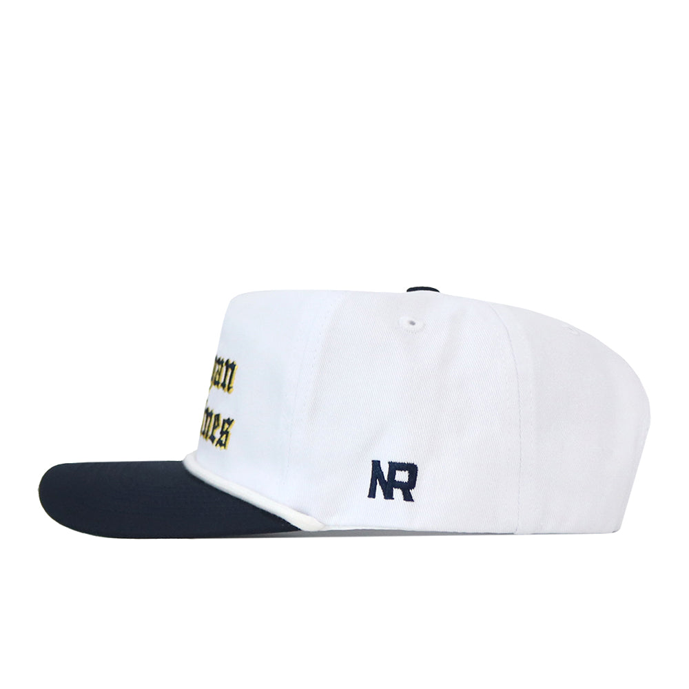No Rivals Michigan Old English Rope Hat, a white baseball cap with a navy blue brim, decorative rope detail, blue Michigan lettering in Old English font, a blue side logo, and an adjustable snap back fit.