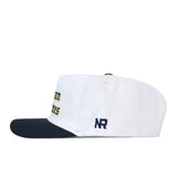 No Rivals Michigan Old English Rope Hat, a white baseball cap with a navy blue brim, decorative rope detail, blue Michigan lettering in Old English font, a blue side logo, and an adjustable snap back fit.