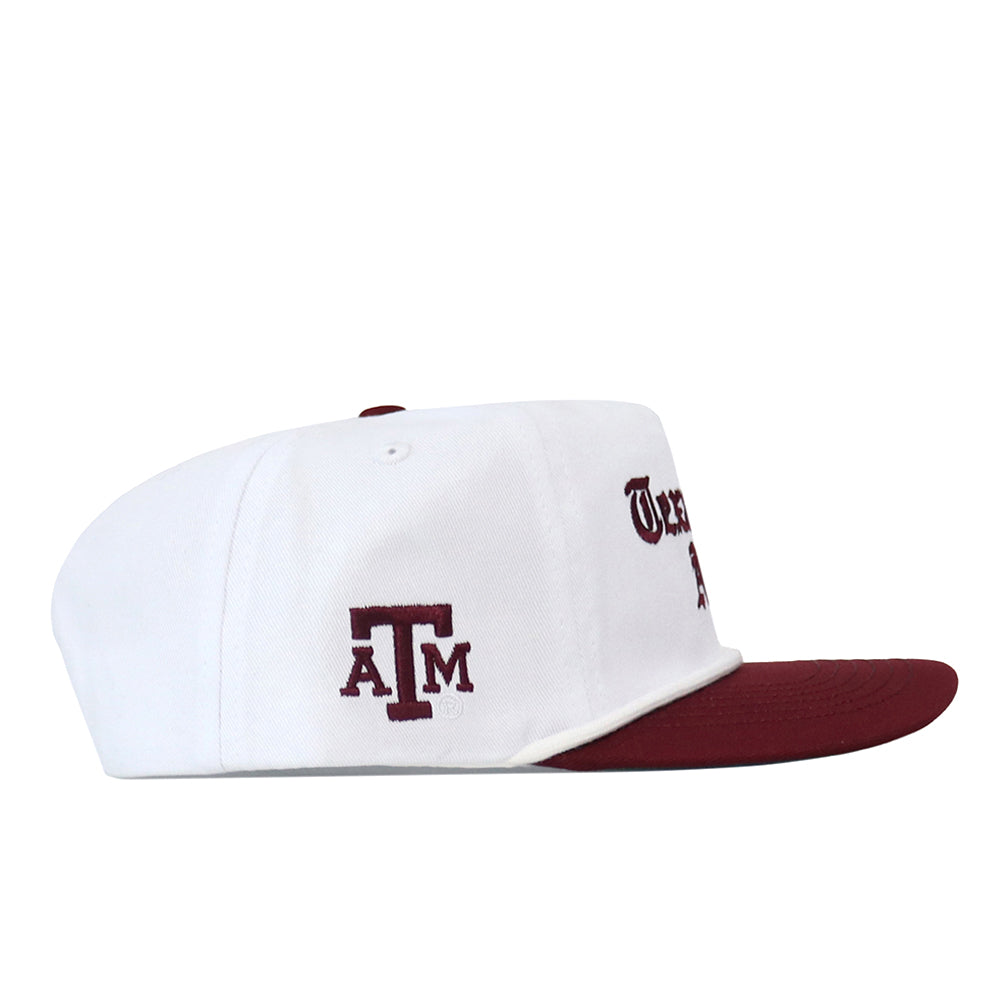 Texas A&M Old English Rope Hat, a white 5-panel baseball cap with a maroon brim, rope detail, maroon A&M lettering on the side, front text, and a snap back adjustment.
