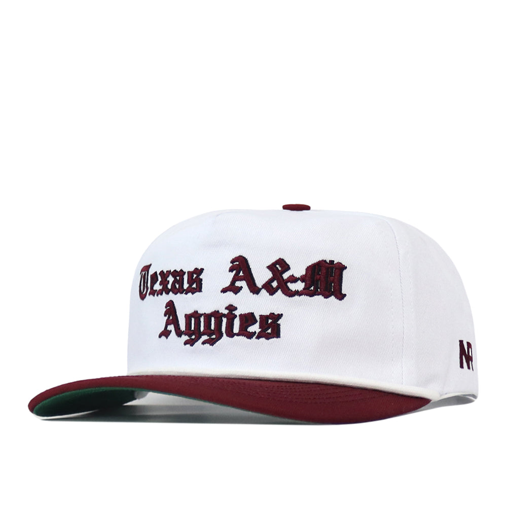 Texas A&M Old English Rope Hat, a white 5-panel baseball cap with a maroon brim, featuring the text Texas A&M Aggies embroidered in maroon Old English lettering and an adjustable snap back.
