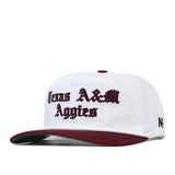 Texas A&M Old English Rope Hat, a white 5-panel baseball cap with a maroon brim, featuring the text Texas A&M Aggies embroidered in maroon Old English lettering and an adjustable snap back.