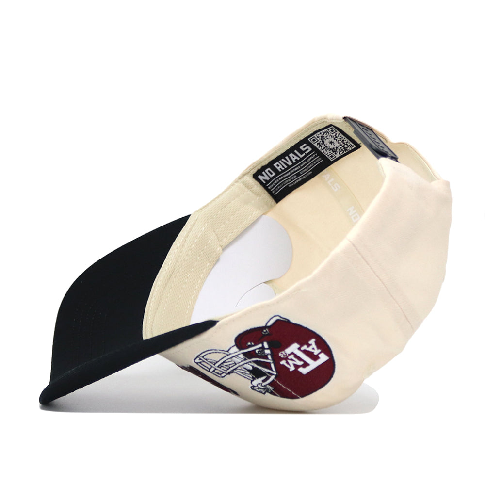 The Texas A&M Alma Mater Hat by No Rivals is a cream and black snapback, shown upside down to display its NO RIVALS tag. The front features a maroon patch with a white football helmet and ATX lettering, made from high quality cotton.