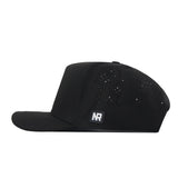 Elevate your Gameday Fit with the No Rivals USF Golf Hat in black, featuring small ventilation holes on the side panel and a flat brim. This essential snap back hat showcases a rectangular embroidered patch with the white NR logo on a black background near the side.