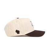 The Marquette Espresso Hat by No Rivals is a cream-colored, structured cotton baseball cap with a dark brown brim and features a small brown Wisconsin silhouette on the side.