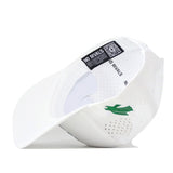 The North Texas Mean Green Football Mascot Hat by No Rivals is displayed upside down, highlighting the embroidered green bird logo on the left side and a NO RIVALS label with a QR code on the inner band. The white cap features a snap back closure for an adjustable fit.