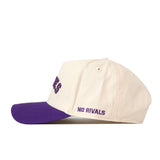 A cream-colored Right Side Up Huskies Hat - UW - Classic by No Rivals, featuring a purple brim and “NO RIVALS” embroidered in purple on the side above the brim. The hat includes a convenient Snap Back Adjustment for a customizable fit.