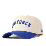 The No Rivals Right Side Up Air Force Hat - Classic Colors is a beige and blue snapback featuring “AIR FORCE” embroidered in blue letters on the front, an official embroidered logo, and “AF” on the left side.