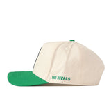 The UNT Desert Scrappy Logo Hat by No Rivals is a cream-colored cotton blend baseball cap with a green brim, shown from the side. “NO RIVALS” is embroidered in green near the back of this snapback hat.