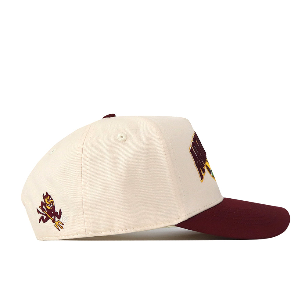 Introducing the Arizona State Sun Devils Stadium Hat by No Rivals—a cream-colored snapback with a maroon brim. This officially licensed cap features a cartoon Sun Devils mascot holding a trident on the front and an embroidered text logo on the side, delivering authentic team spirit with detailed stitching throughout.