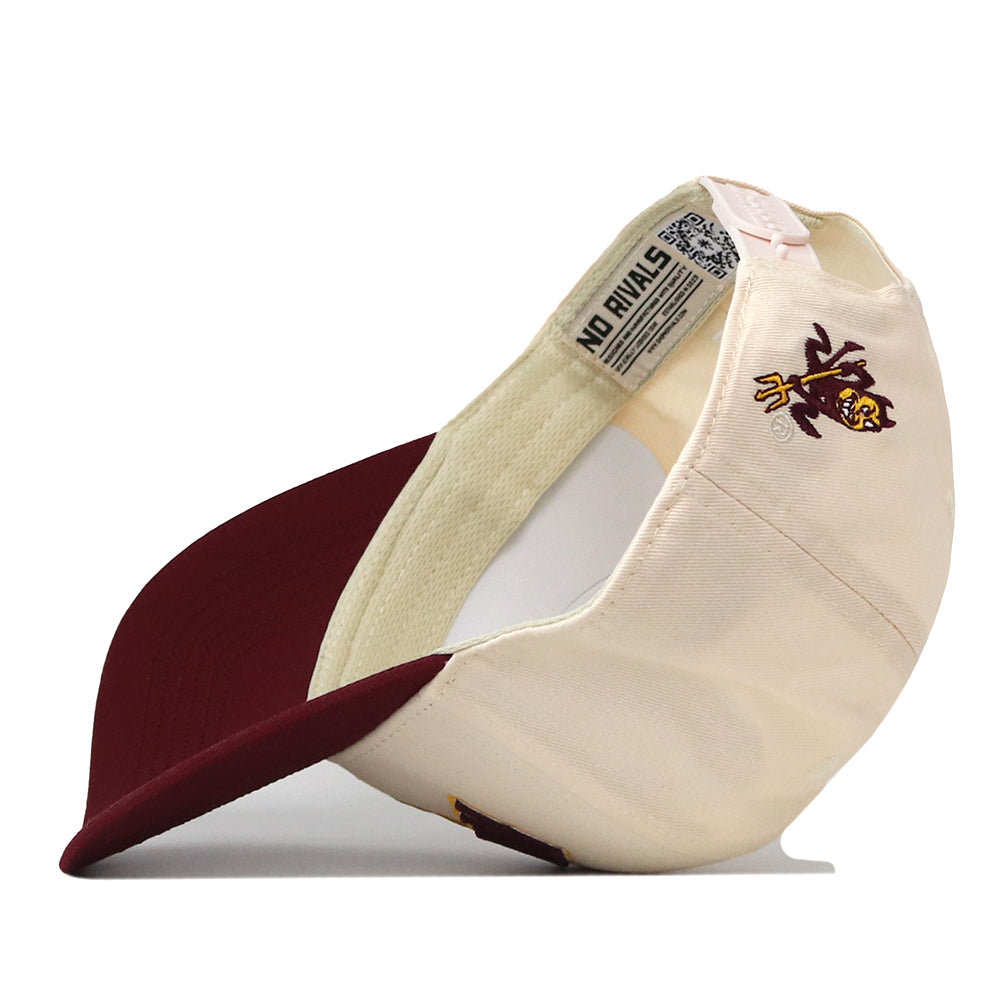 The Arizona State Sun Devils Stadium Hat by No Rivals is displayed upside down, revealing an officially licensed devil mascot logo on the side and the words “NO RIVALS” on the inner band. Embroidered logos enhance the premium feel of this cream and maroon snapback cap.