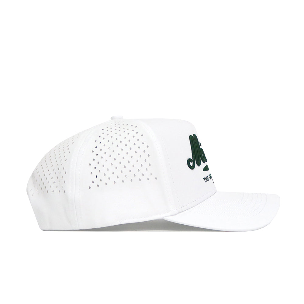 Side view of the No Rivals Michigan Clubhouse Hat in white, made from a polyester-cotton blend with small ventilation holes, green "Malbon" lettering on the front, a flat brim, and snapback closure.