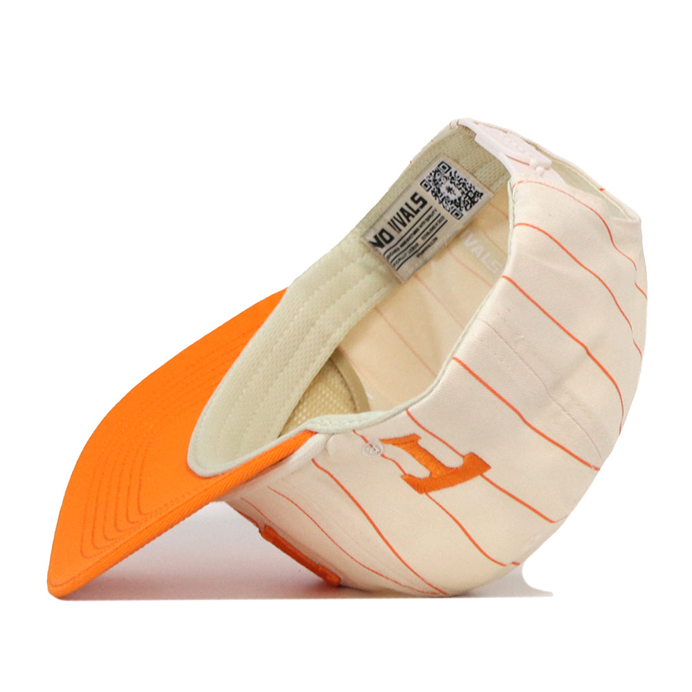 The Tennessee Pinstripe Traditions Hat by No Rivals is shown upside down, revealing its interior tags, labels, and signature orange pinstripes. The exterior features an embroidered letter H logo in orange and white. Crafted from a comfortable cotton blend, this cap includes a classic snap back closure for an adjustable fit.