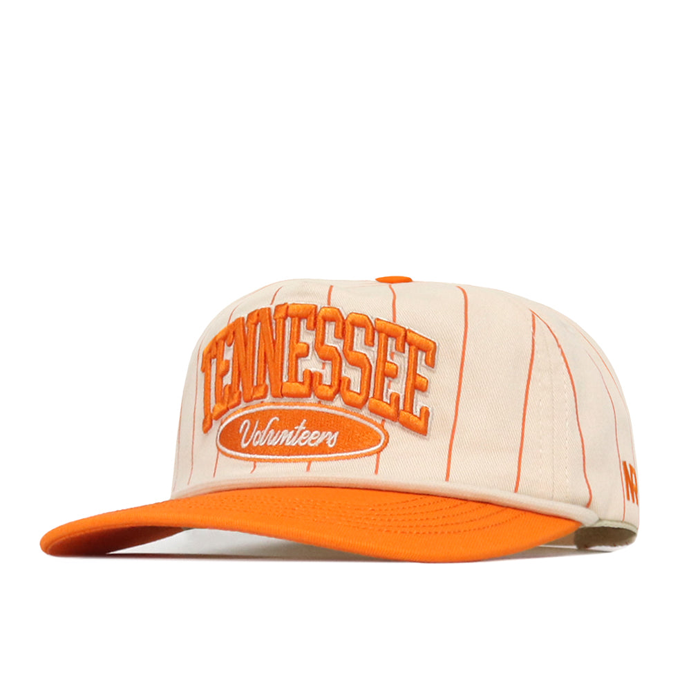 The No Rivals Tennessee Pinstripe Traditions Hat features a beige cotton blend design with thin orange stripes, an orange brim, and “Tennessee Volunteers” embroidered in orange and white on the front. It includes a snap back closure for adjustable fit and a bold embroidered logo to showcase your team pride.