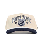The No Rivals Penn State Vintage Block Hat is an officially licensed cream and navy blue baseball cap featuring “Penn State Nittany Lions 1855” and a detailed embroidered lion logo on the front, with a convenient snap back adjustment for a comfortable fit.