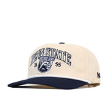 The No Rivals Penn State Vintage Block Hat is an officially licensed snapback in cream and navy blue, featuring an embroidered Nittany Lions logo, “PENN STATE” text, and the numbers 1855 on the front.