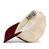 The Florida State Seminoles Stride Hat by No Rivals is pictured upside down, revealing its inner lining, branded label, and a QR code tag. This structured fit snapback cap combines cream and maroon colors and is crafted from high-quality cotton for lasting comfort and durability.