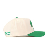 The North Dakota Fighting Hawks Stadium Hat by No Rivals is a cream-colored snapback with a green visor, displayed here in a side view. It features a green embroidered logo on the side and an additional front design that’s partially visible—making it the perfect addition to your gameday fit.