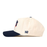 The Illinois Fighting Illini Stadium Hat by No Rivals is a cream-colored snapback with a navy blue brim, featuring the NR initials embroidered in navy on the side and high-quality embroidered logos for a stylish, polished look.