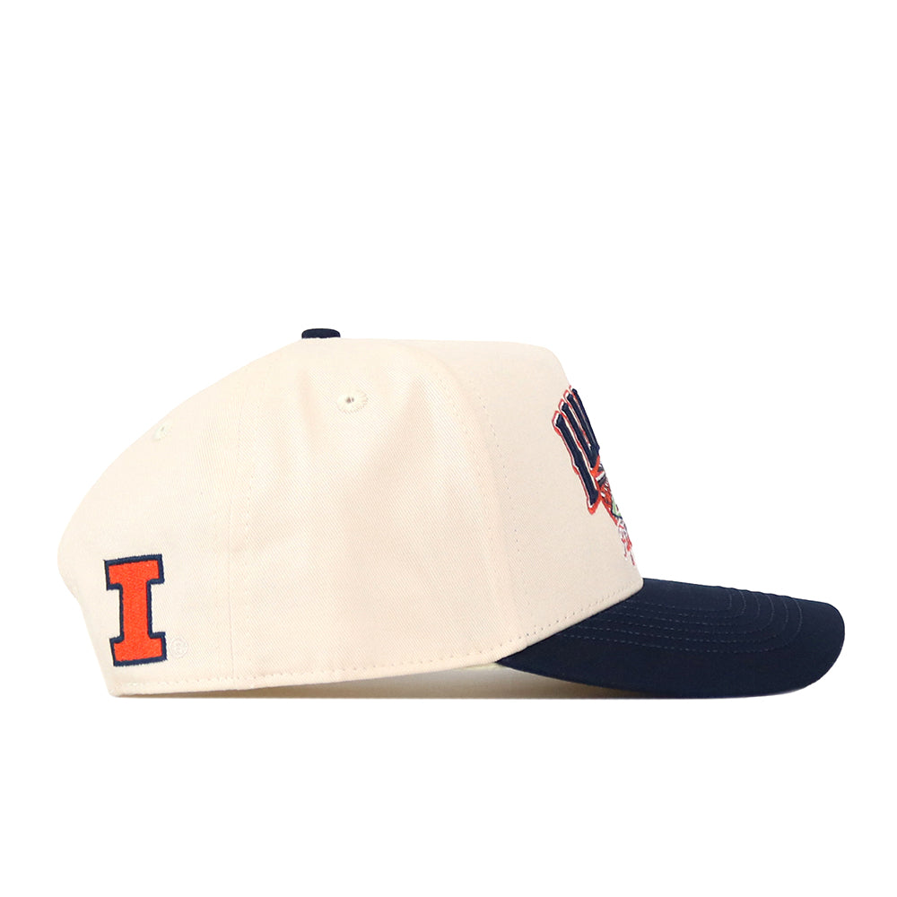 The No Rivals Illinois Fighting Illini Stadium Hat is an officially licensed snapback cap in cream with a navy blue brim, highlighted by an orange letter I patch on the side and embroidered logos on the front for a classic look with standout details.