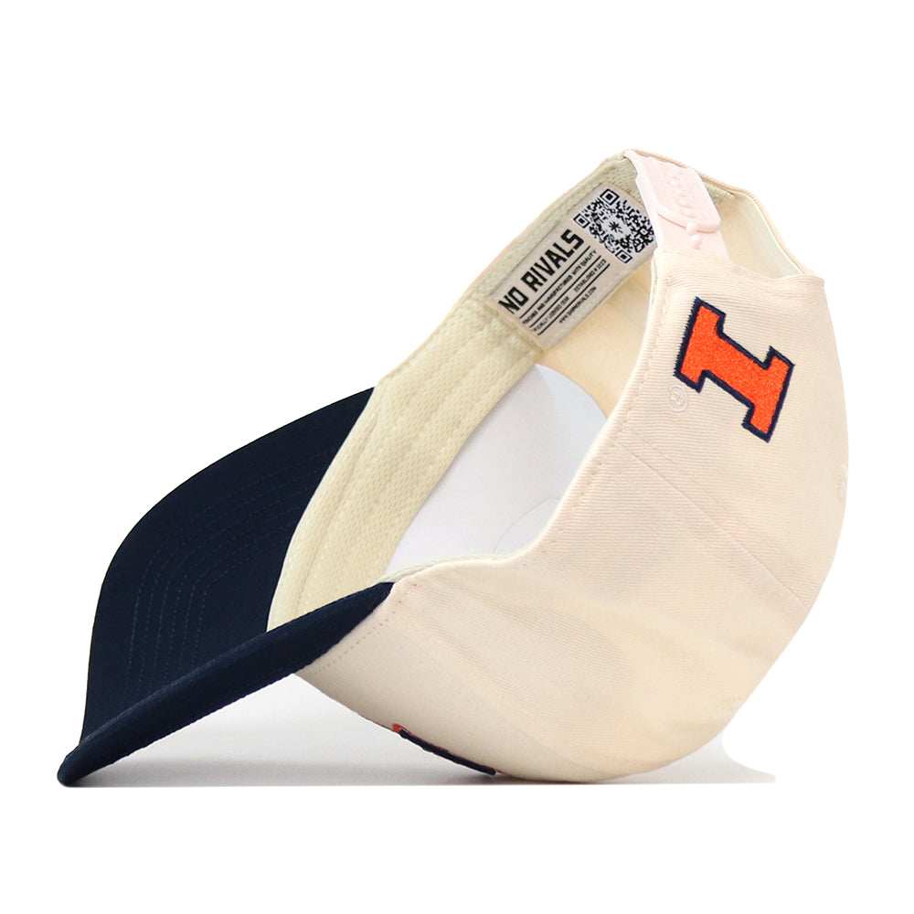 A cream and navy Illinois Fighting Illini Stadium Hat by No Rivals featuring a red and blue embroidered “I” logo on the front. The snapback hat is shown flipped to display its interior label and adjustable strap, emphasizing its quality as an officially licensed product.