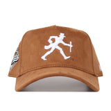 The Wake Forest Heritage Hat by No Rivals is a brown suede snapback baseball cap with a white embroidered walking man in a top hat and cane on the front, and a patch on the left side.