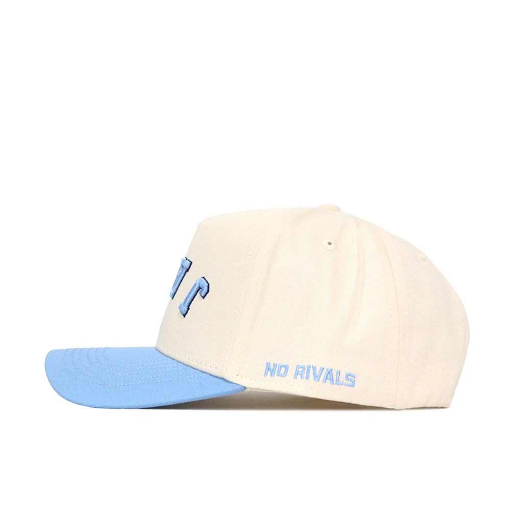 The Upside Down JAYS Hat - Creighton by No Rivals features a cream crown, light blue brim, structured fit, and "NO RIVALS" embroidered in blue on the side.