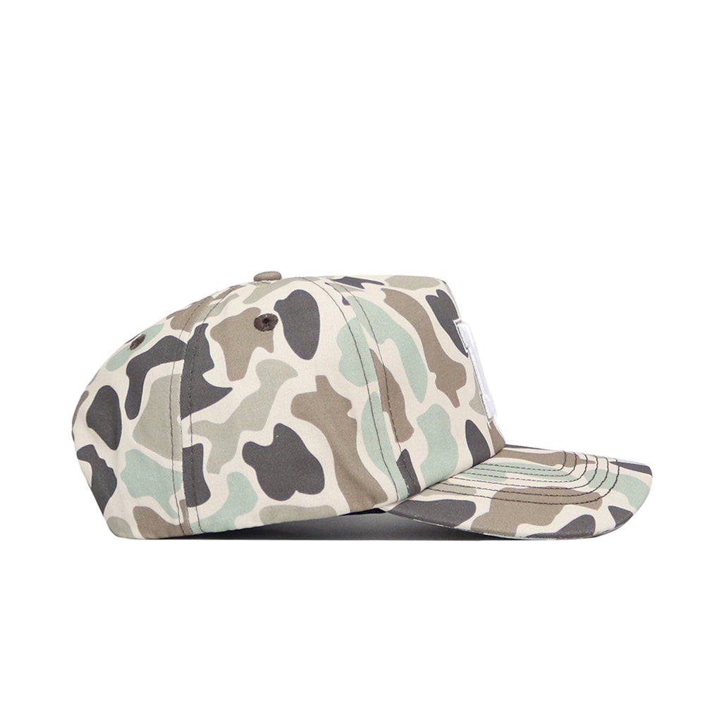 A side view of the Nebraska Huntsman Hat by No Rivals, featuring a green, brown, beige, and black camo pattern. This 5-panel cap has a flat brim, stitched ventilation on top, and an adjustable snap back closure for a perfect fit.