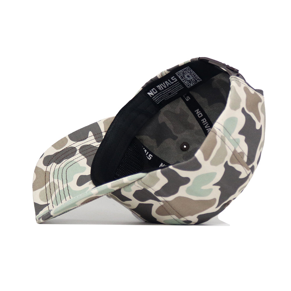 The Tennessee Huntsman Hat by No Rivals is displayed upside down, showing a black inner band with "NO RIVALS" in white. This 5-panel snapback cap features classic green, brown, and beige camouflage shades.