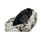The Tennessee Huntsman Hat by No Rivals is displayed upside down, showing a black inner band with "NO RIVALS" in white. This 5-panel snapback cap features classic green, brown, and beige camouflage shades.
