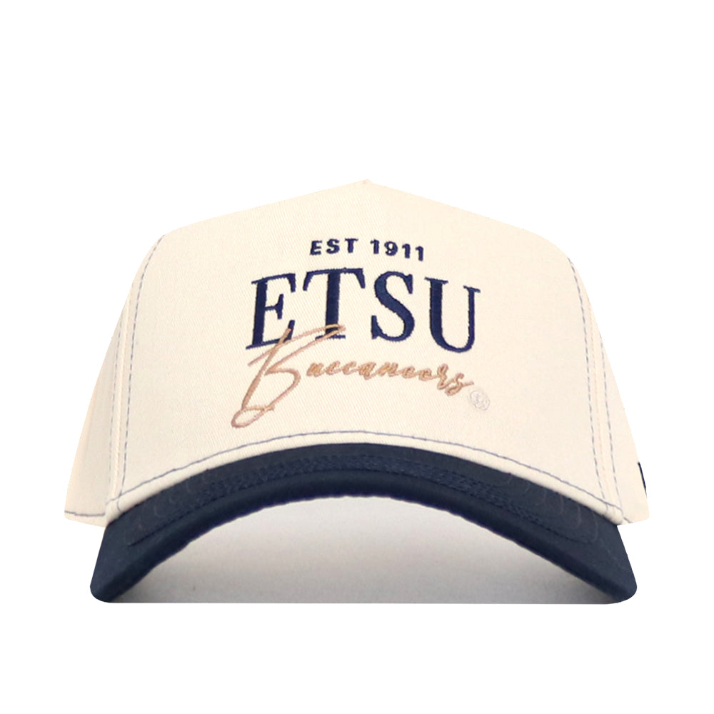 The No Rivals ETSU Vintage Hat is a cream cap with a navy brim, featuring “EST 1911 ETSU Buccaneers” embroidered on the front. This structured snapback is made from high quality cotton for all-day comfort and style.