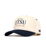 The ETSU Vintage Hat by No Rivals is a cream and navy snapback with "EST 1911 ETSU Buccaneers" on the front and "NR" on the side. This structured cap features a curved brim, ventilation holes, and is made from high-quality cotton for comfort.