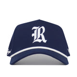 The Rice Guys Hat - Navy by No Rivals features a navy blue design, white embroidered R logo on the front, white brim trim, and an adjustable snap back closure.