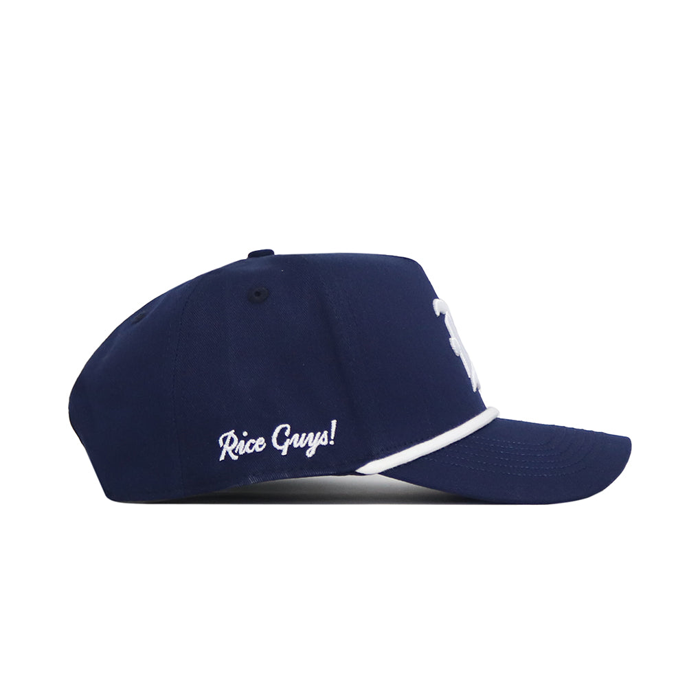 The Rice Guys Hat - Navy by No Rivals is a structured navy cap with white piping on the brim and “Rice Guys!” embroidered in white on the side, displayed in a side view against a white background.
