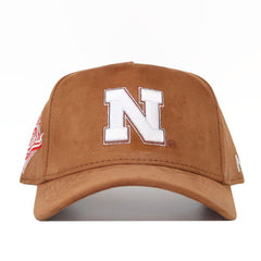 The Nebraska Heritage Hat by No Rivals is a brown suede snapback featuring a large white N on the front and bold white and red embroidered side logos. Enjoy an adjustable fit for all-day comfort.