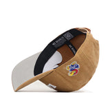 The Kansas Rustic Hat by No Rivals is a tan cotton canvas snapback with a light gray brim, colorful embroidered bird and KU on the front, a white side tag, and "NO RIVALS" text inside.