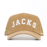 Front view of the South Dakota State Rustic Hat by No Rivals. This tan cotton canvas snapback has "JACKS" in large white letters on the front and a small yellow graphic on the structured cap's left side.