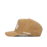 The South Dakota State Rustic Hat by No Rivals is a tan cotton canvas cap with "NO RIVALS" embroidered in white above the ear and part of a large white logo visible on the structured front.