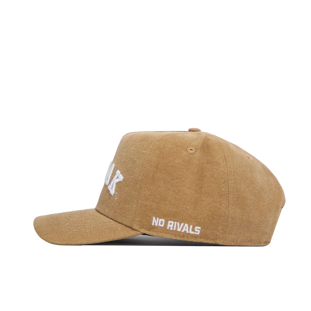 The North Dakota Rustic Hat by No Rivals is a brown cotton canvas Structured Fit cap with white "NO RIVALS" embroidery above the curved brim and a top button, shown from the side.