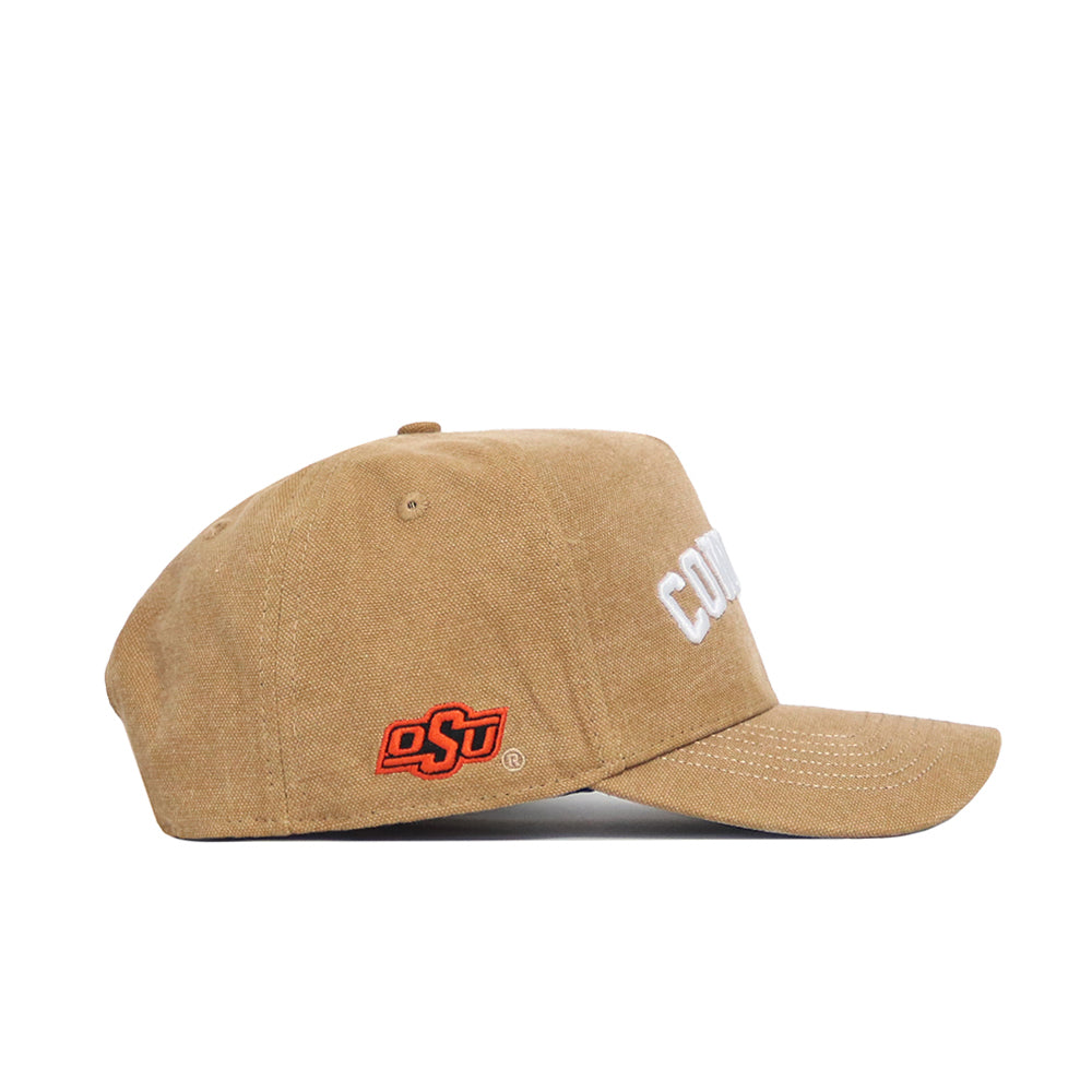 The No Rivals Oklahoma State Rustic Hat is a tan cotton canvas snapback with "COWBOYS" in white on the front and an orange OSU logo on the side. This structured cap is shown from a side angle against a white background.