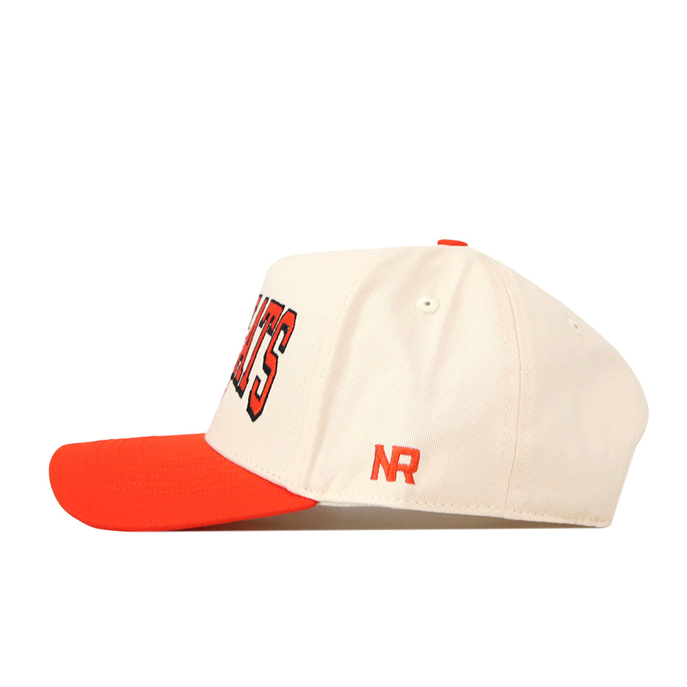 The SHSU Bearkats Retro Block Hat by No Rivals features a cream-colored crown with an orange brim, red NR lettering on the side, and partially visible black and orange embroidery on the front. This stylish embroidered baseball cap is perfect for completing your gameday fit.