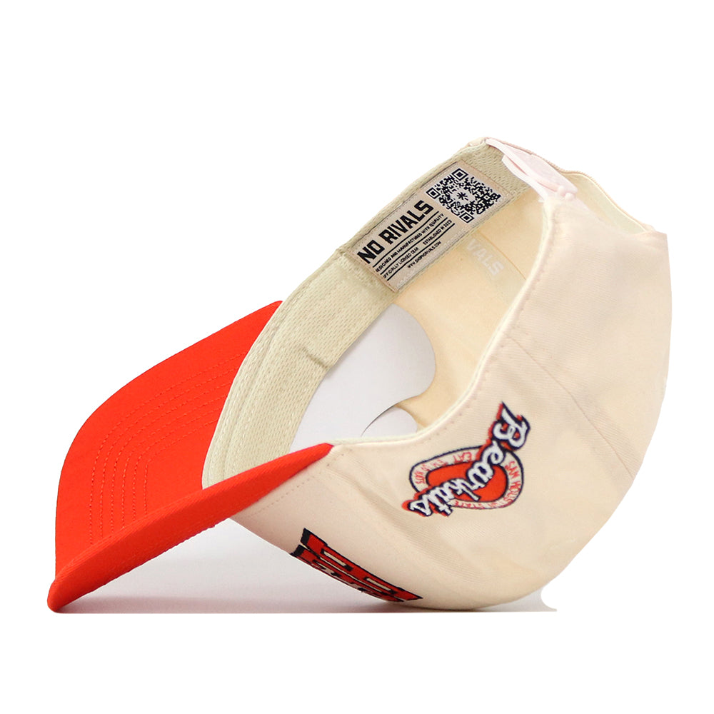 The SHSU Bearkats Retro Block Hat by No Rivals is a licensed snapback baseball cap featuring a bold red brim and beige crown, worn tilted sideways for added style on gameday. An inside tag displays the NO RIVALS logo alongside a QR code, while the exterior showcases “Rivals” and an embroidered patch featuring the number 23.