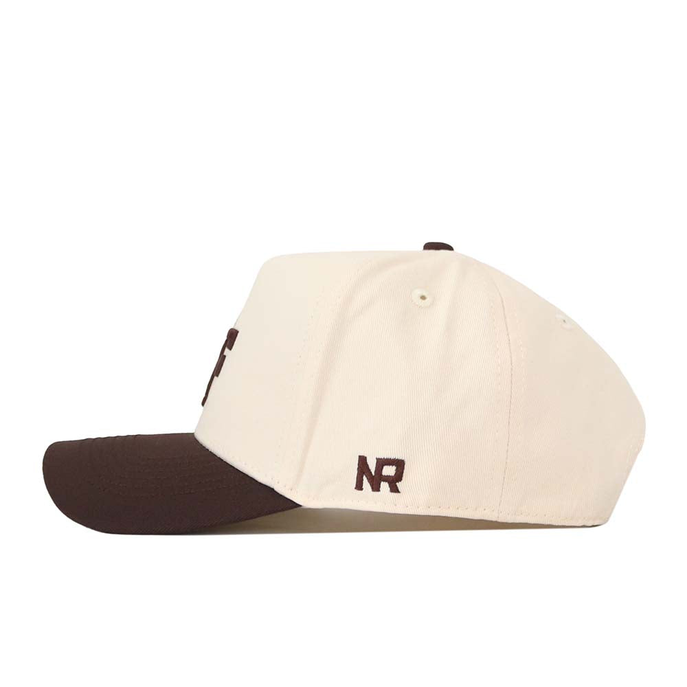 The No Rivals Air Force Espresso Hat is a cream-colored baseball cap with a dark brown brim, shown in a side view. The brown embroidered “NR” logo is featured above the brim, and this officially licensed snapback offers a structured fit for lasting shape and comfort.