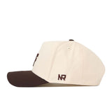 The No Rivals Air Force Espresso Hat is a cream-colored baseball cap with a dark brown brim, shown in a side view. The brown embroidered “NR” logo is featured above the brim, and this officially licensed snapback offers a structured fit for lasting shape and comfort.